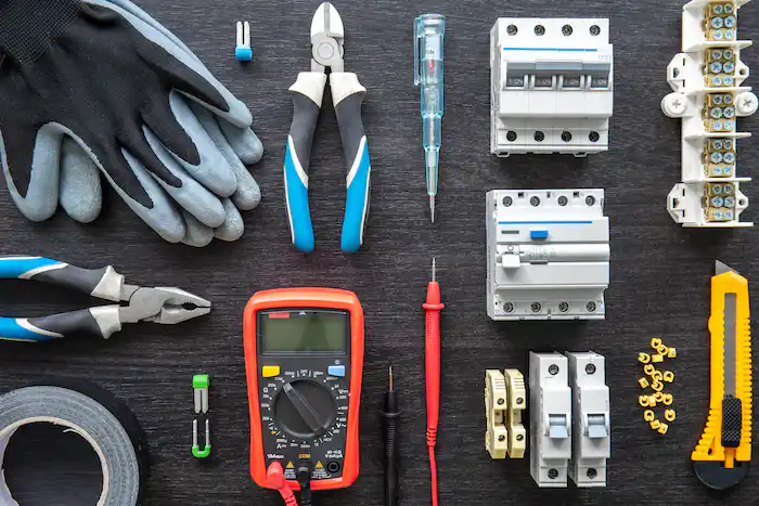 Electrical tools and components arranged on a dark surface